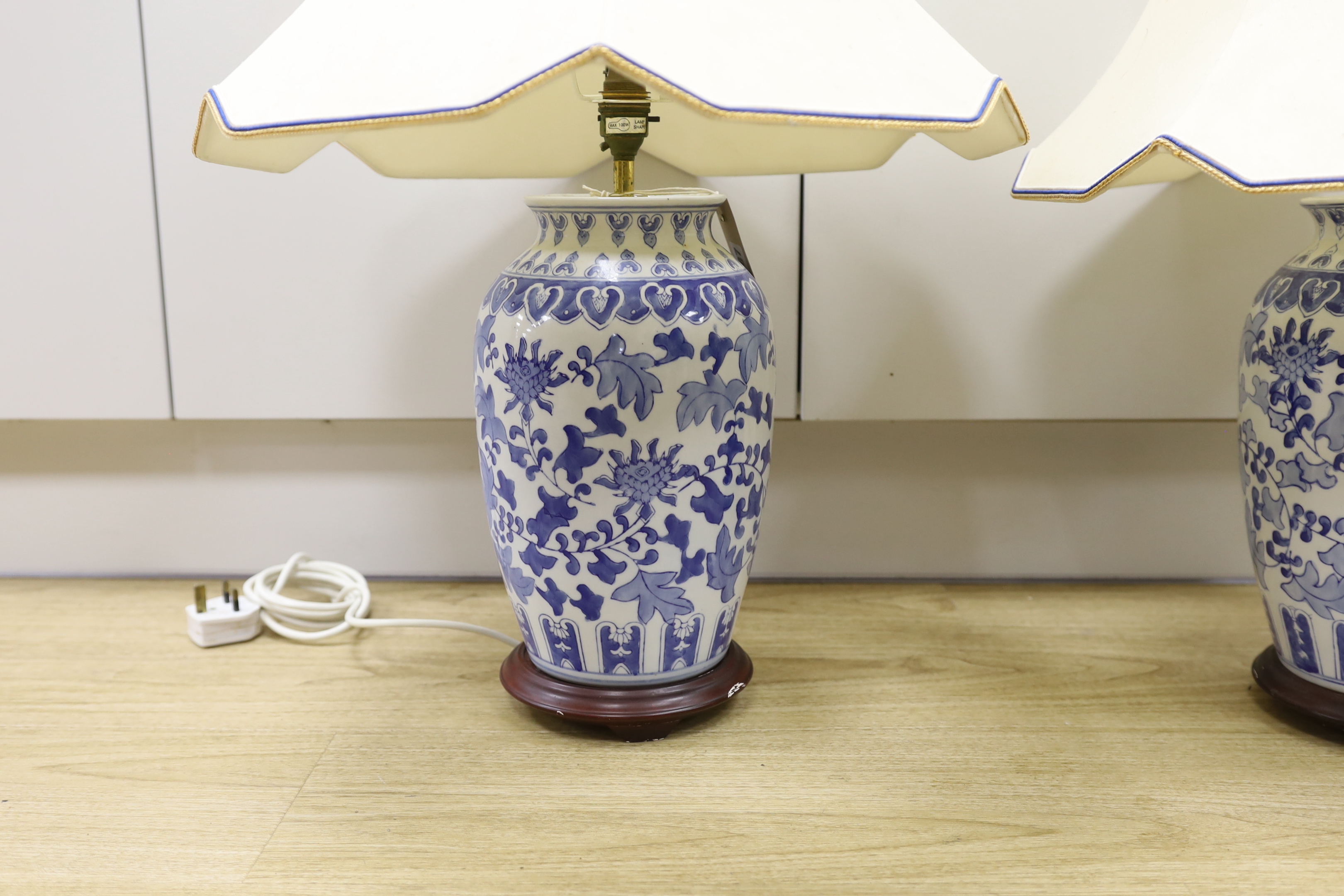 A pair of Chinese blue and white vases, converted to table lamps, overall 69cm high